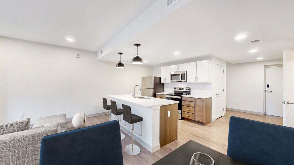 a living room and kitchen with a table and chairs at Current812, Indiana