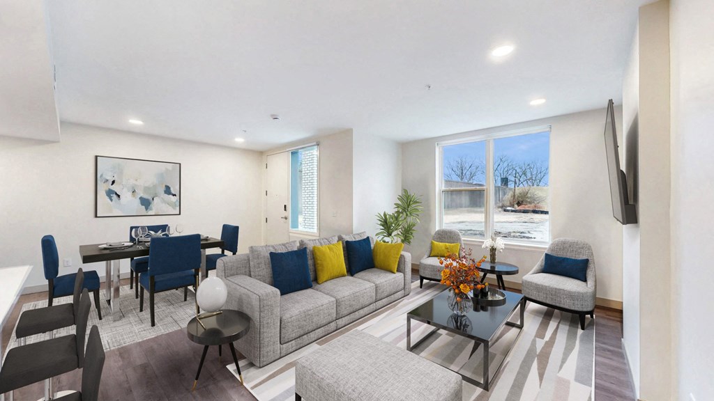 a living room with a couch and a table with chairs at Current812, Clarksville, IN