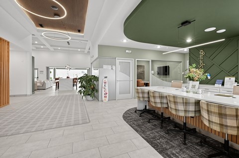 A modern office space with a reception desk and seating area.