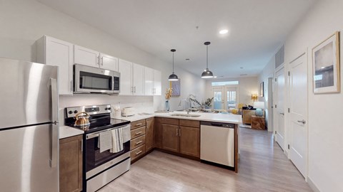 a kitchen with stainless steel appliances and white cabinets
