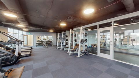 Fitness center with cardio and weight equipment at Current812 Apartments, Clarksville, IN 47129