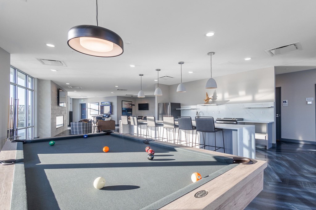 a clubhouse with a pool table and a kitchen with a bar at Current812, Clarksville Indiana