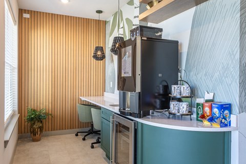 a kitchen with a counter with a refrigerator and a sink