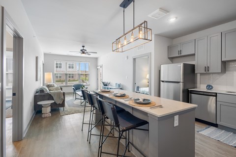 A kitchen with a table and chairs in the middle of the room.