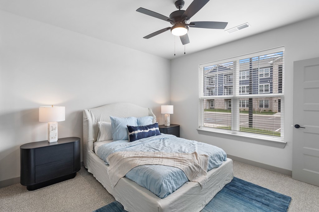 Bedroom with cozy bed at The Warren Apartments, Jeffersonville, IN