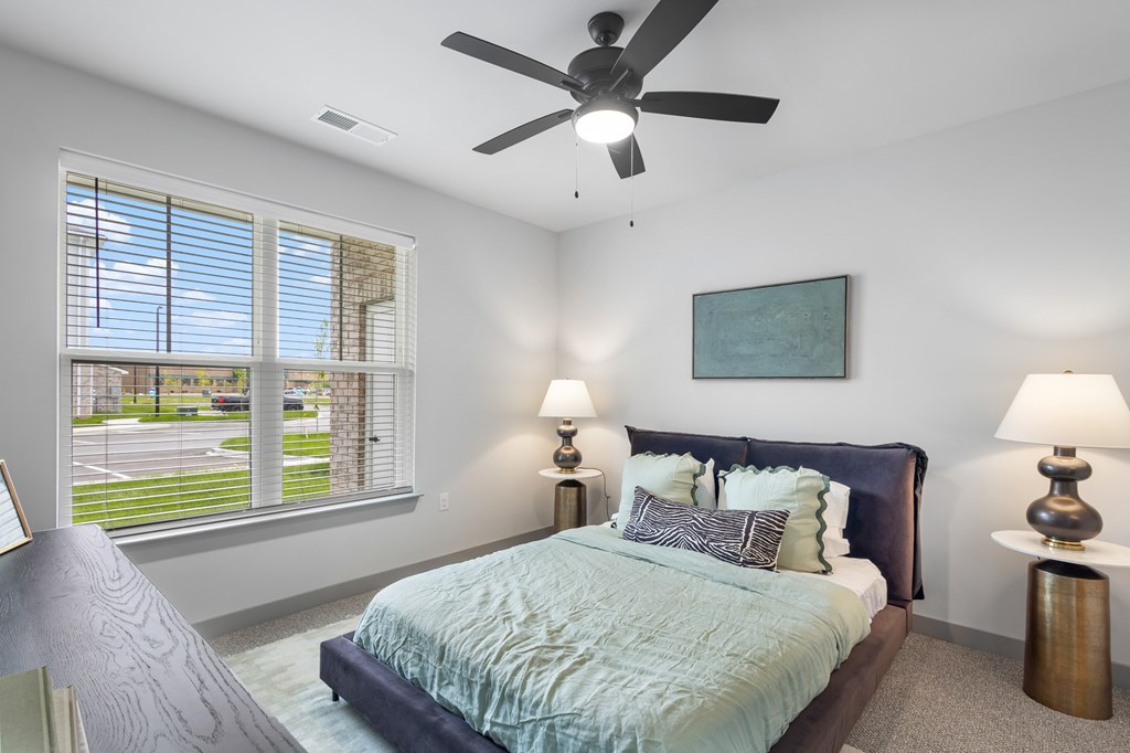 Bedroom with window view at The Warren Apartments, Jeffersonville, IN