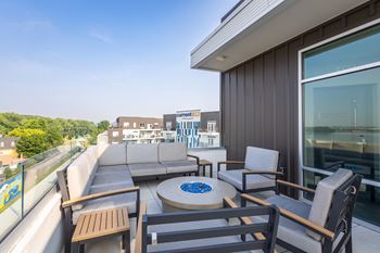 A patio with a table and chairs overlooking a building.