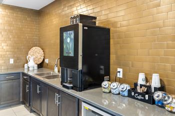 A coffee machine is on a counter in a kitchen.