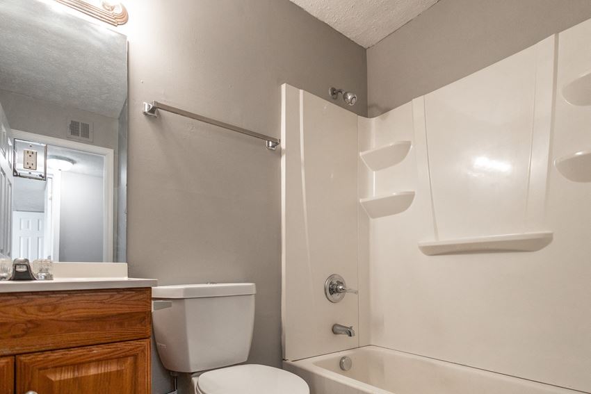 a bathroom with a toilet and a bathtub - Photo Gallery