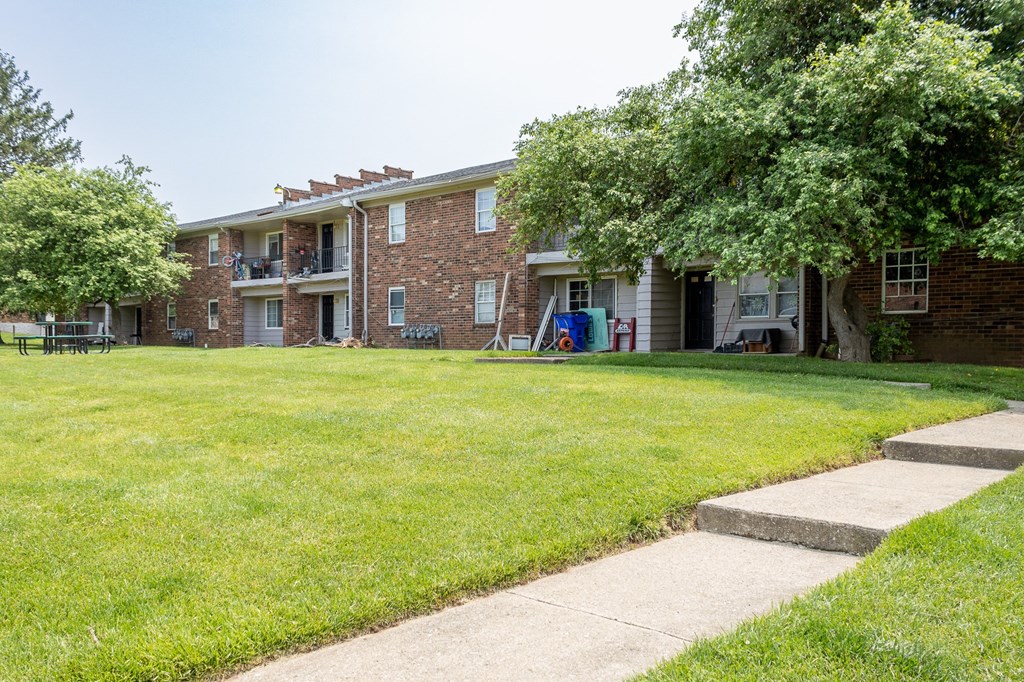 a grassy area with a building in the background at Caballo Crossing, Lexington, Kentucky
