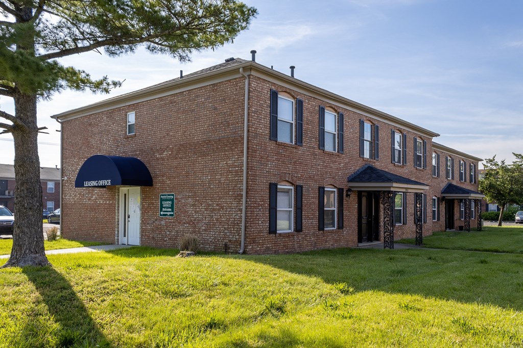 a brick building with a blue awning