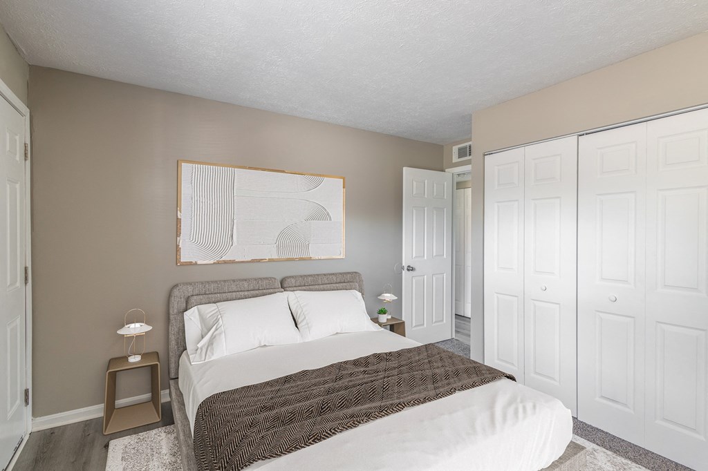 a bedroom with a bed and two closets