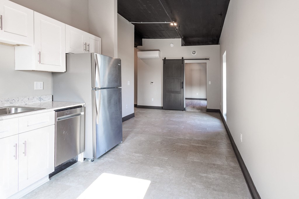 a kitchen with white cabinets and stainless steel appliances