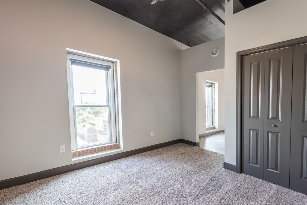 an empty room with a window and a door