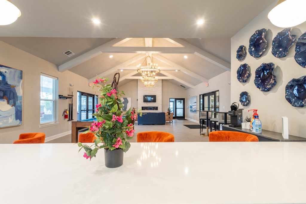 a large white table with orange chairs in a room with blue plates on the wall at Sage Springs, Kentucky