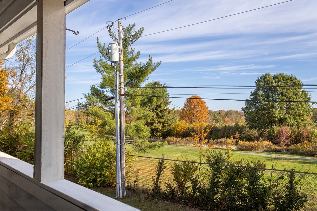 a view of a field from a window of a house