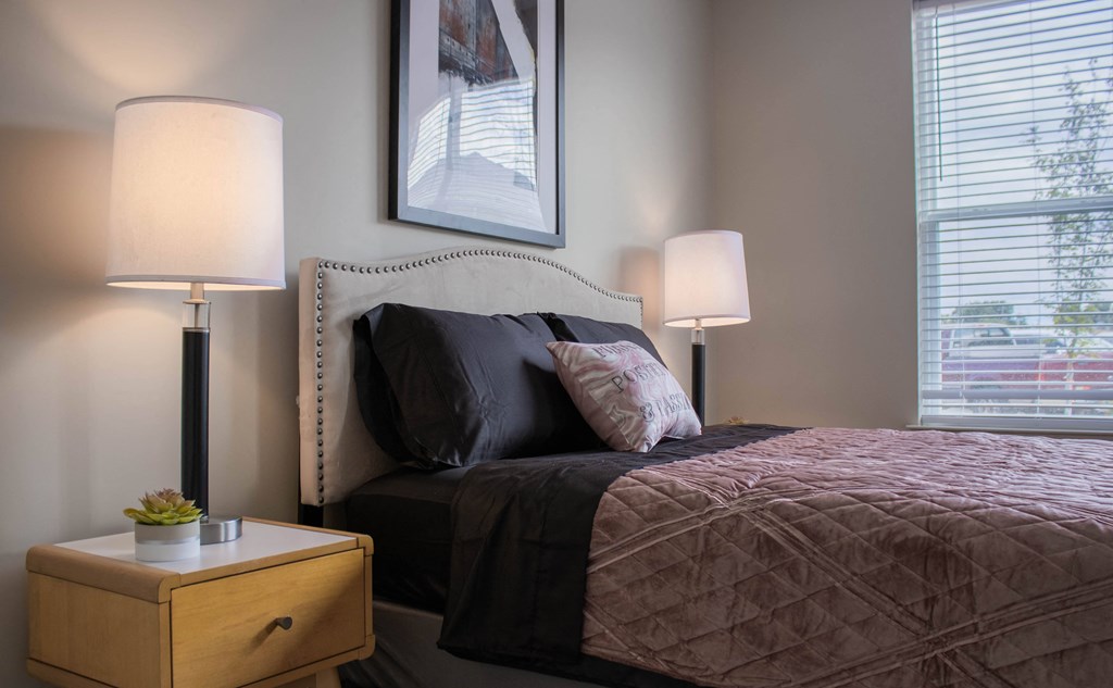 a bedroom with a bed and two lamps and a window at Arlington Farms, Greenwood, IN