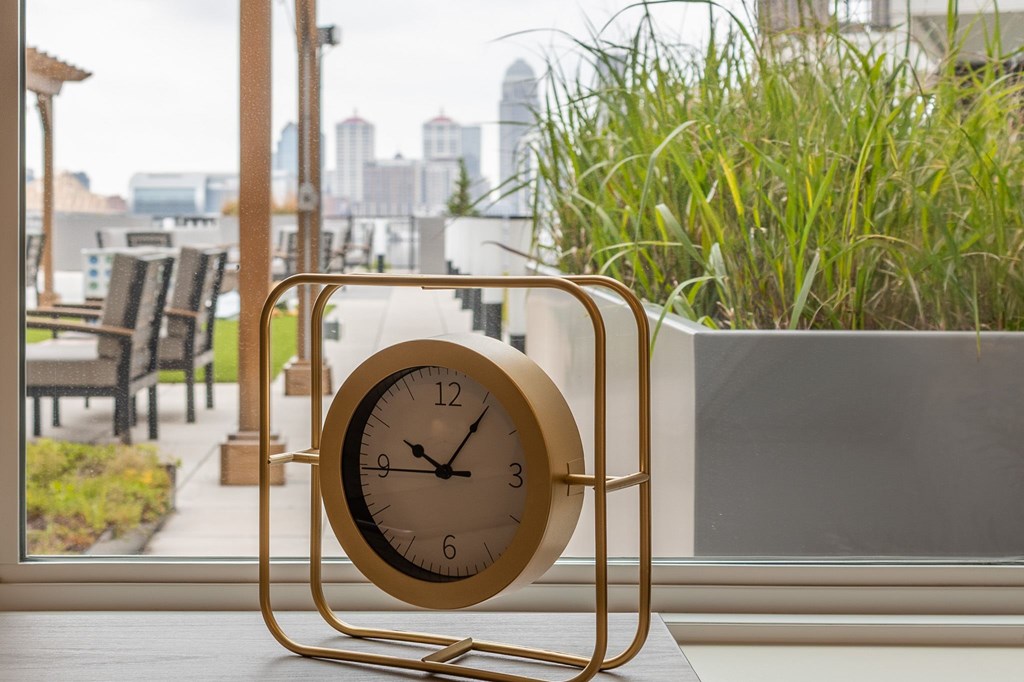 A clock is sitting on a table in front of a window at Current812, Clarksville, IN