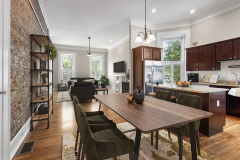 A modern kitchen with a wooden table and chairs.