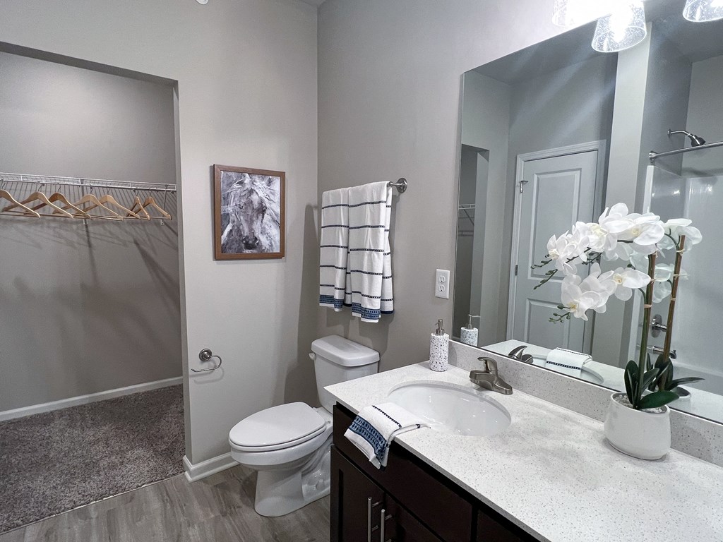 a bathroom with a sink and a toilet and a shower at Arlington Farms, Greenwood, IN