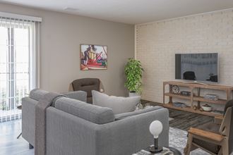 a living room with a couch and two chairs