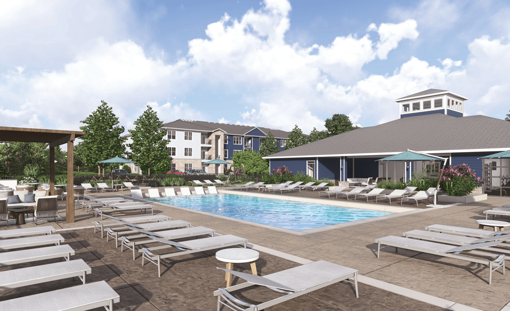 an aerial view of a swimming pool with lounge chairs and a building in the background