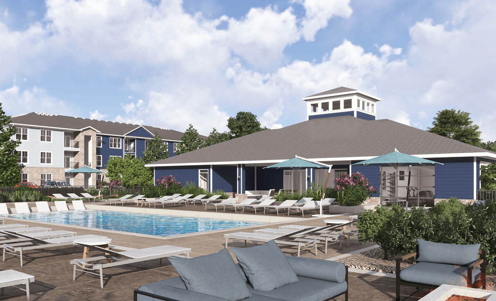 a pool with lounge chairs and umbrellas in front of a building