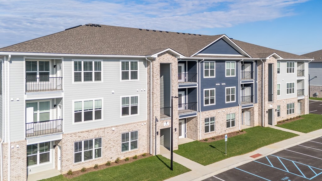 Apartment complex with a parking lot in front at The Warren Apartments, Jeffersonville, IN, 47130