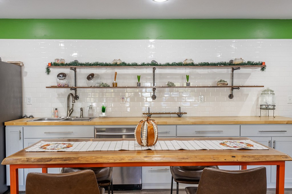 a large kitchen with a wooden table and chairs