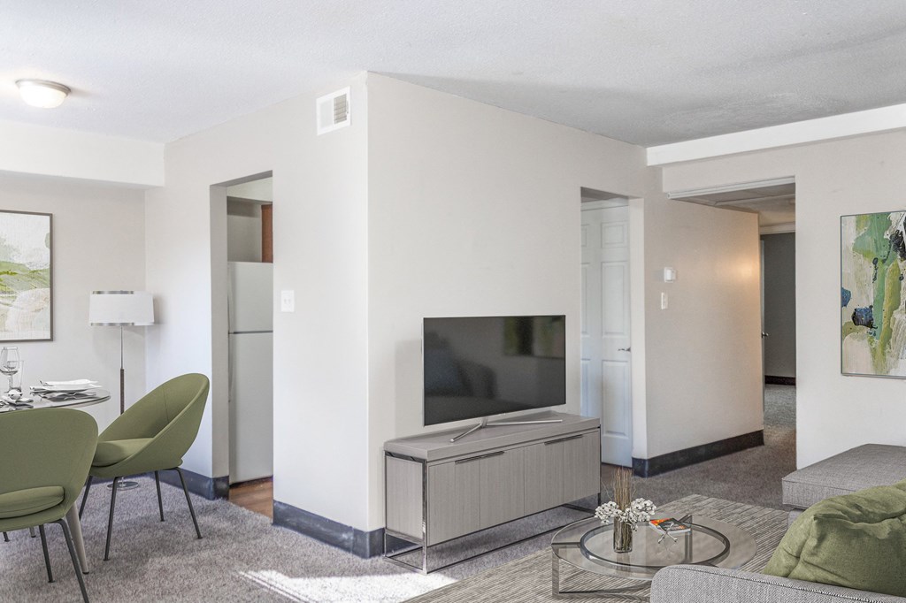 a living room with white walls and a flat screen tv