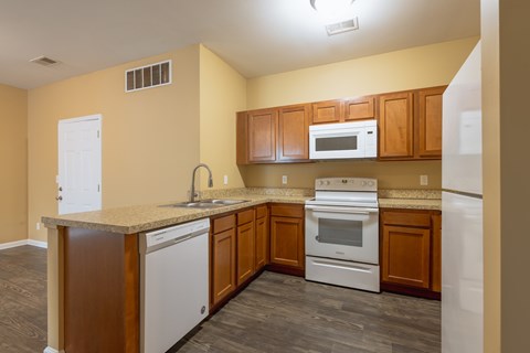 A kitchen with wooden cabinets and stainless steel appliances.
