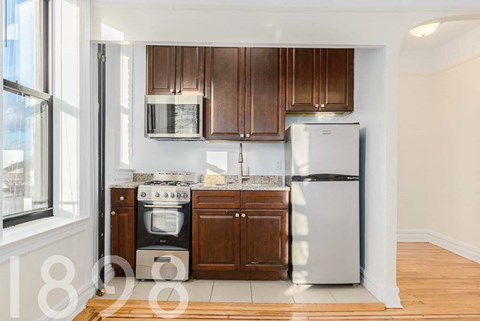 A kitchen with a stove, oven, and refrigerator.