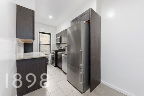 A modern kitchen with a large refrigerator and a countertop.