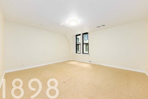 A room with a large number 1898 on the floor.
