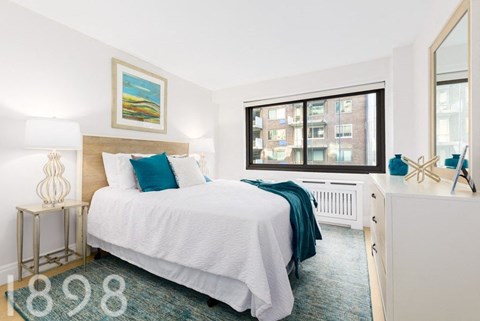 a bedroom with a bed and a window