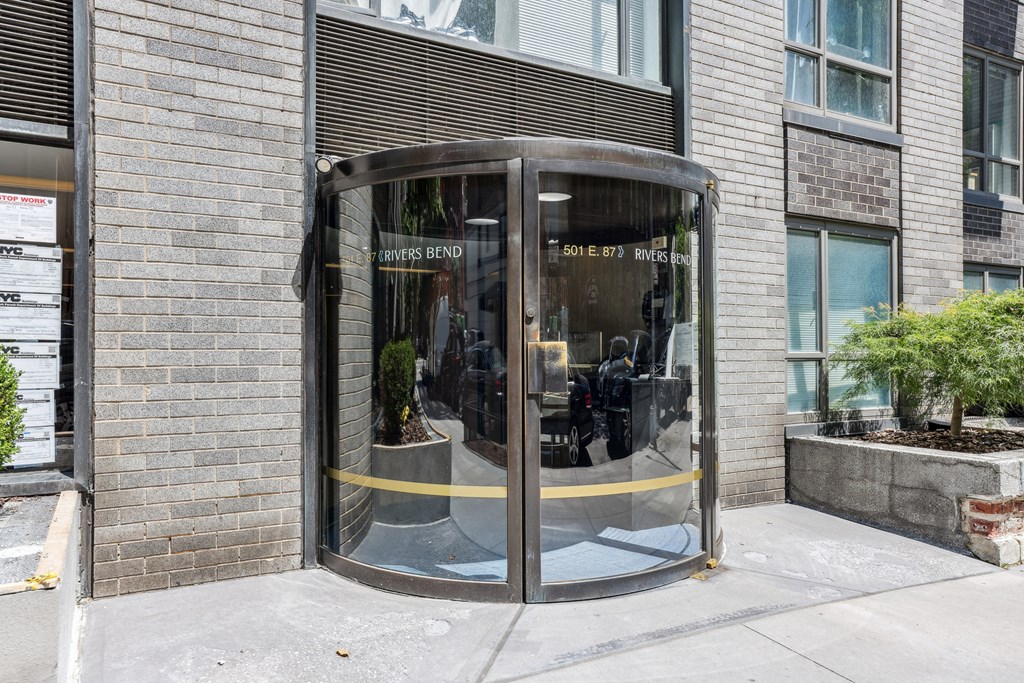 A glass door with a yellow line on the bottom of it.