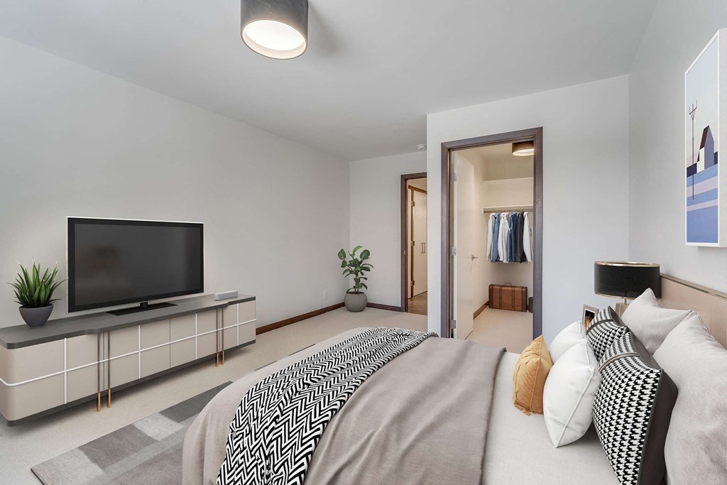 a bedroom with a large bed and a tv