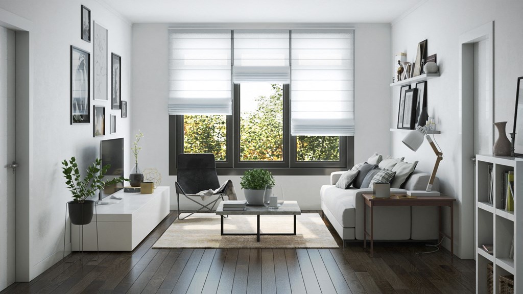 a living room with a white couch and a window