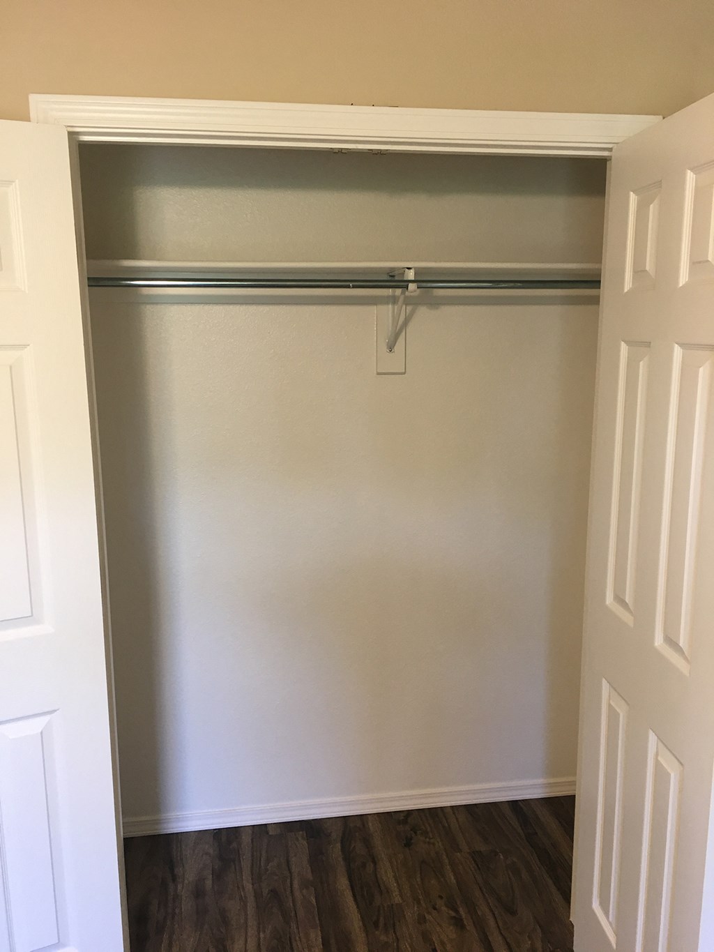 the closet in the master bedroom has a large sliding closet door