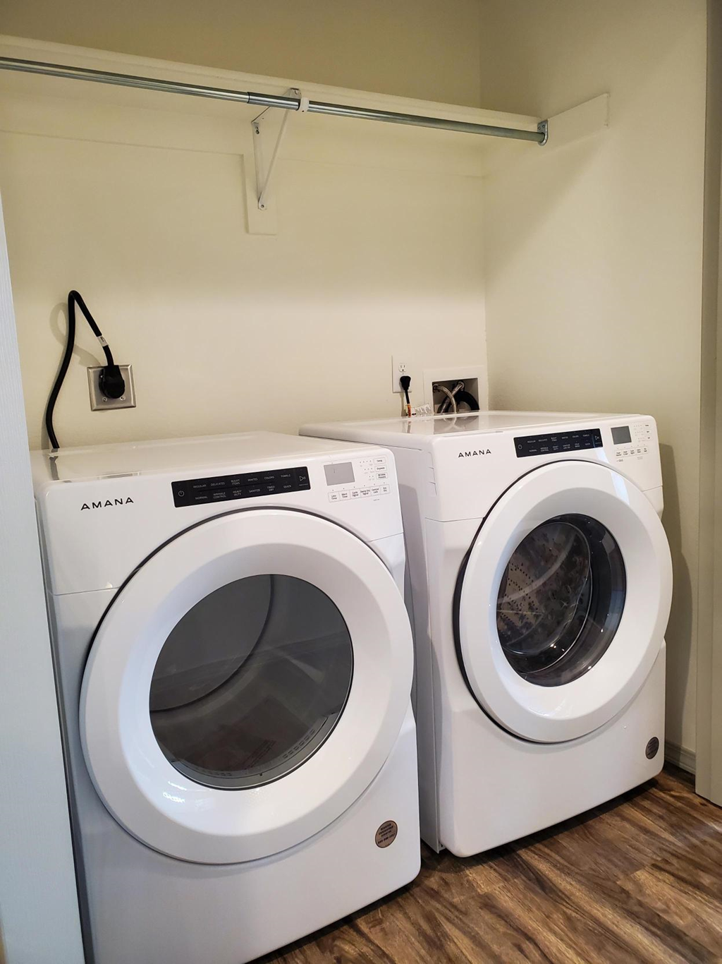 two washing machines in a laundry room with a washer and dryer