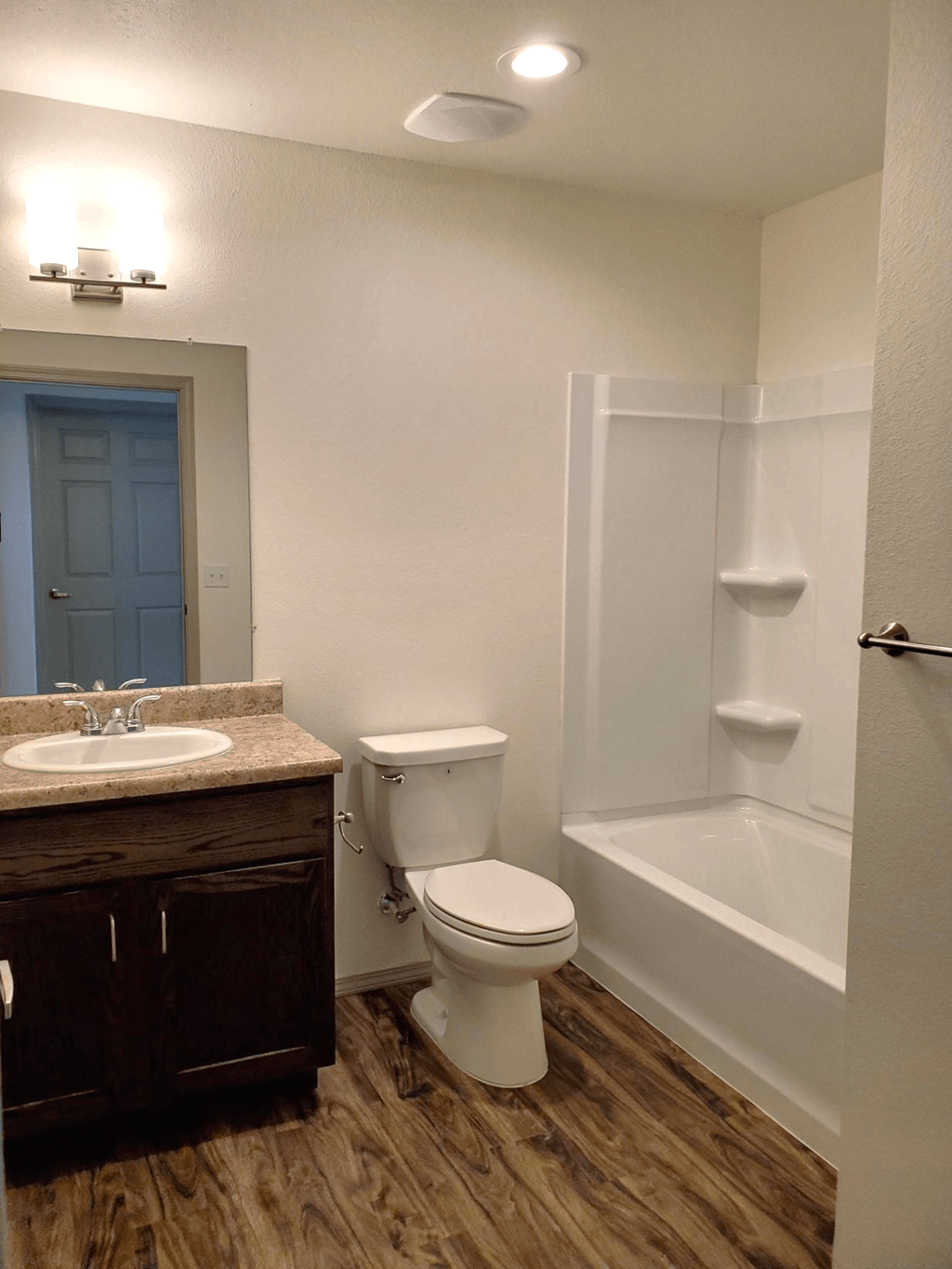 a bathroom with a toilet and a sink and a bath tub