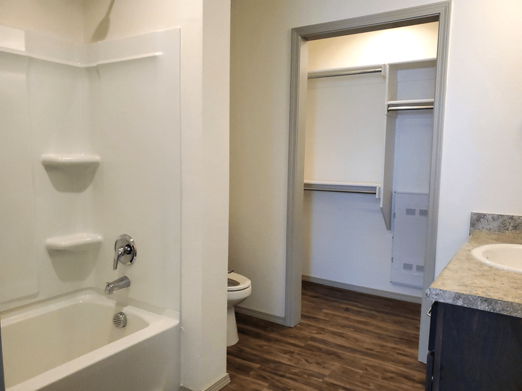 a bathroom with a tub and a sink and a toilet