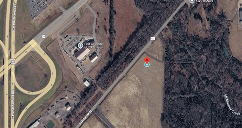 A satellite image shows a road intersection with a red marker and a blue marker.