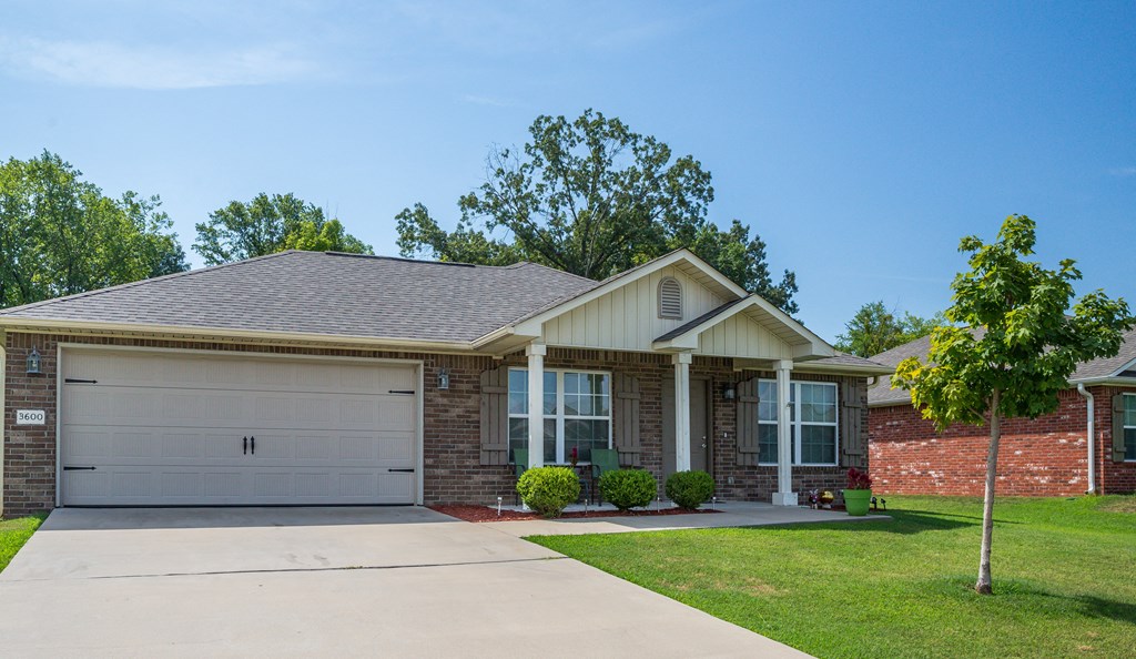 a house with a white garage door and a lawn