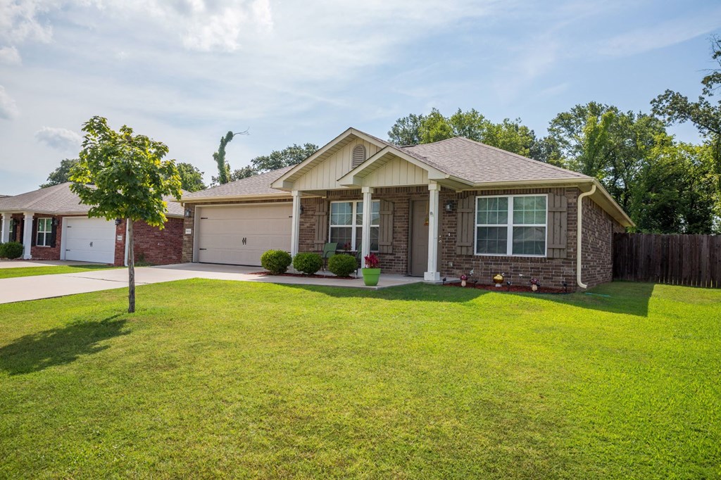 a house with a lawn and a tree