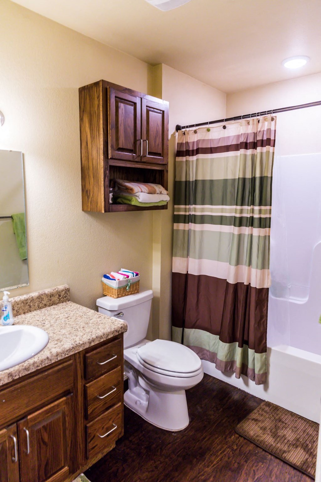 a bathroom with a shower and a toilet and a sink
