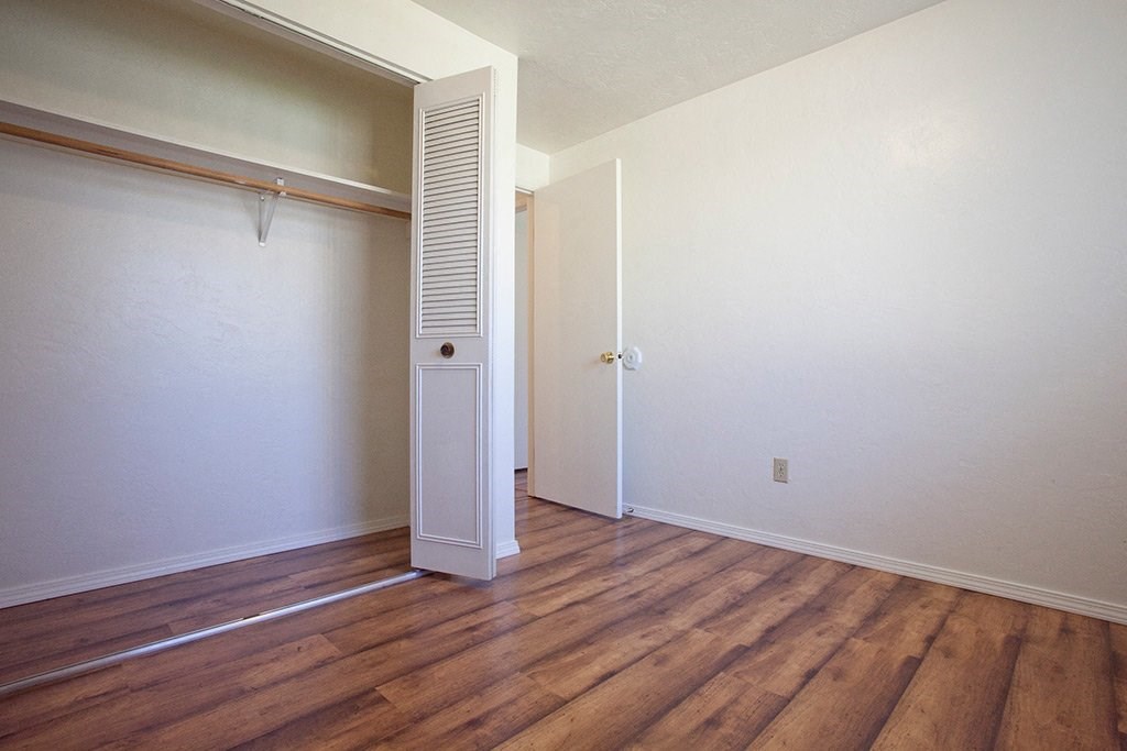 an empty room with a closet and a door