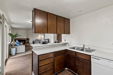 A kitchen with brown cabinets and a white counter.