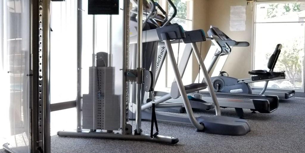 a gym with weights and other equipment on the floor