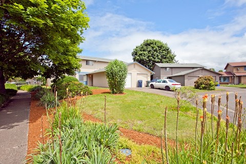 a house with a yard and a car parked in front of it